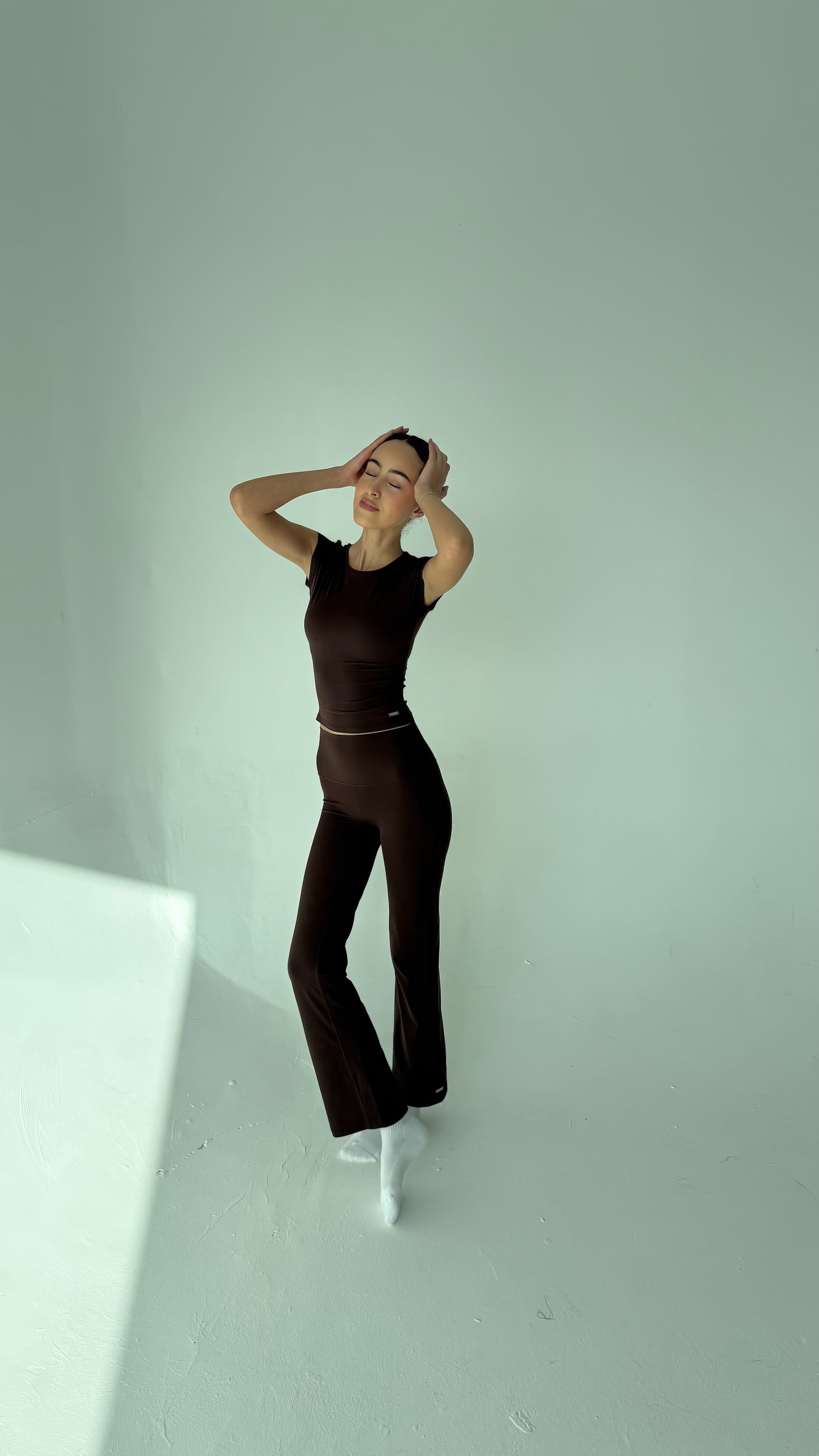 Mannequin wearing a black jumpsuit against a white background